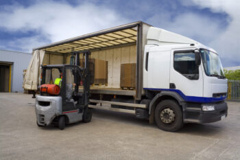 LPG forklift truck in operation loading a warehouse van