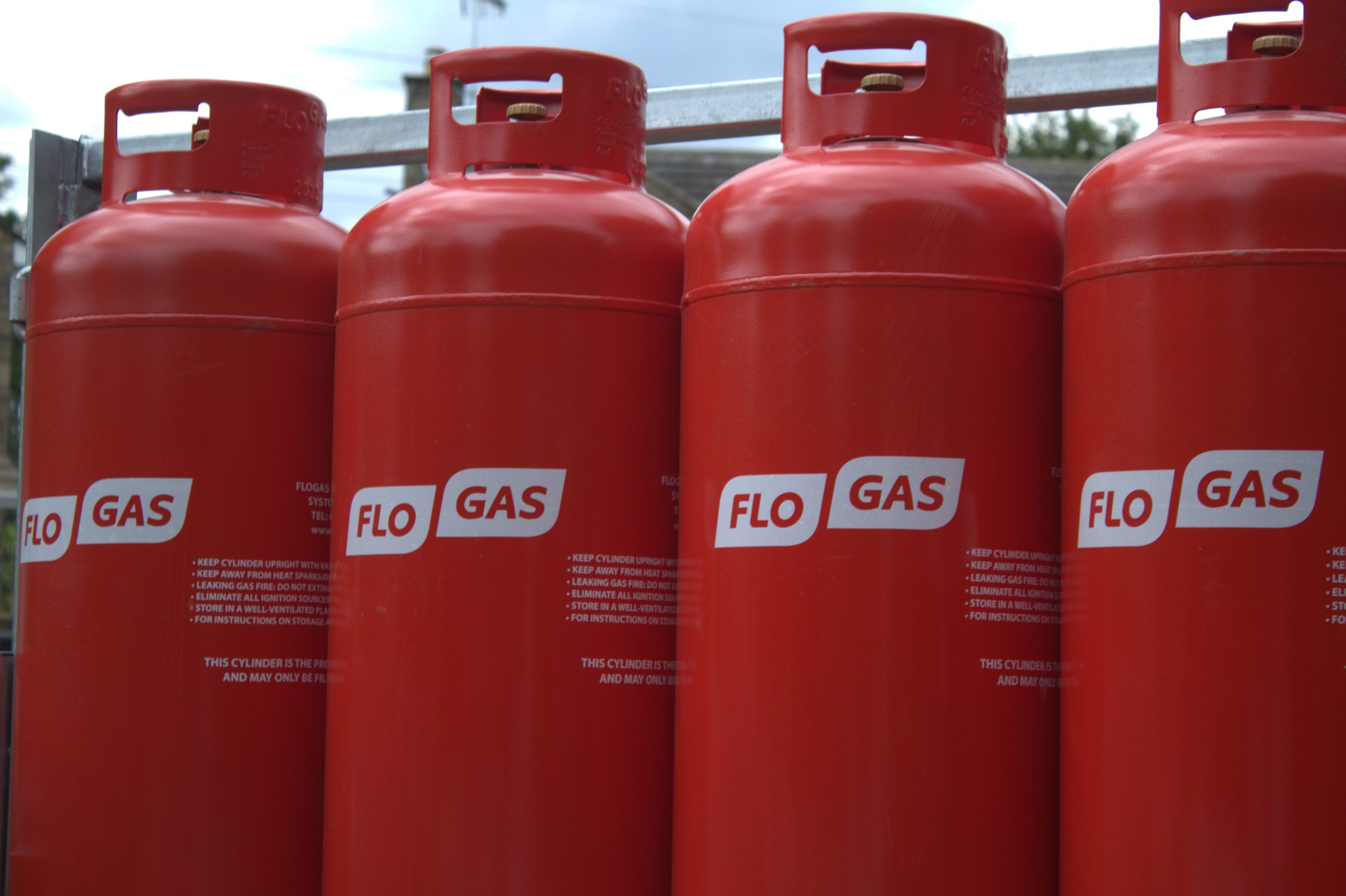 four red 47kg propane bottles